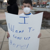 A boy demonstrates against oil and gas development in Broomfield County prior to the county's public meeting.