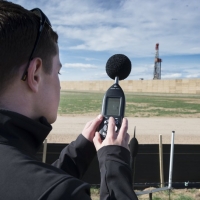 A researcher from CU Denver records noise levels from a oil drill rig in a Greeley, CO neighborhood.